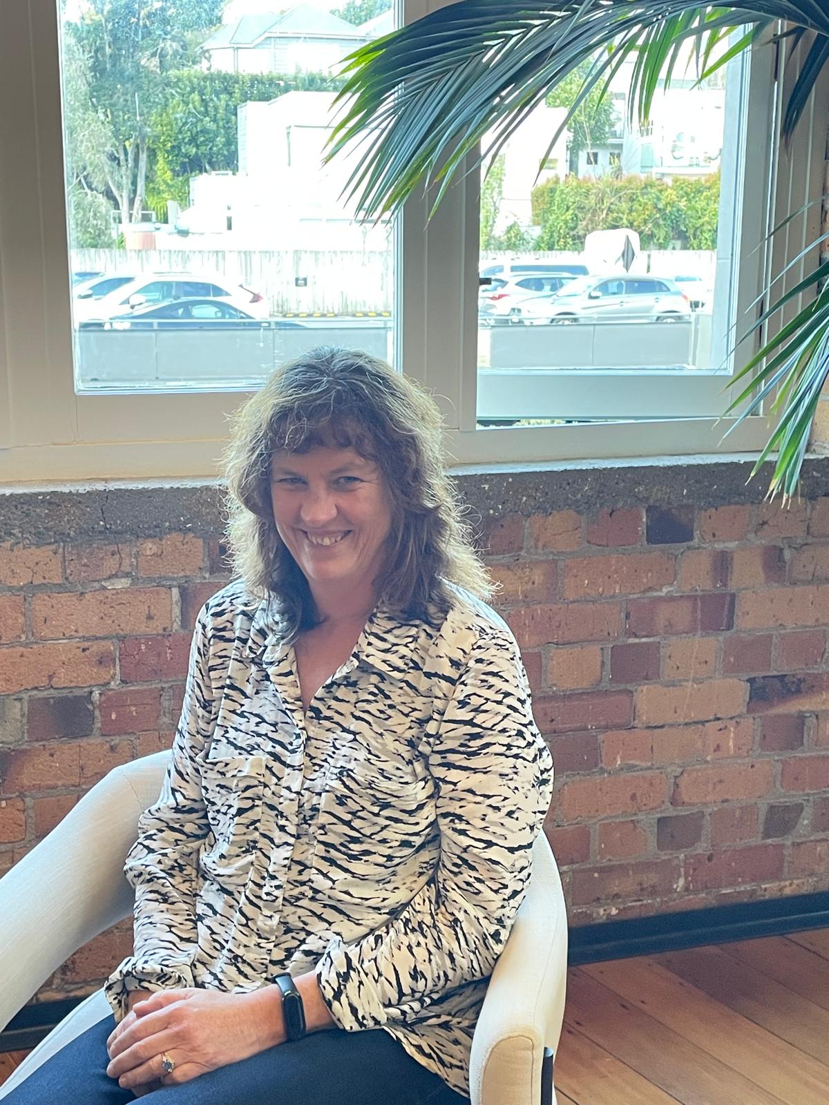 Janet sitting on a chair 